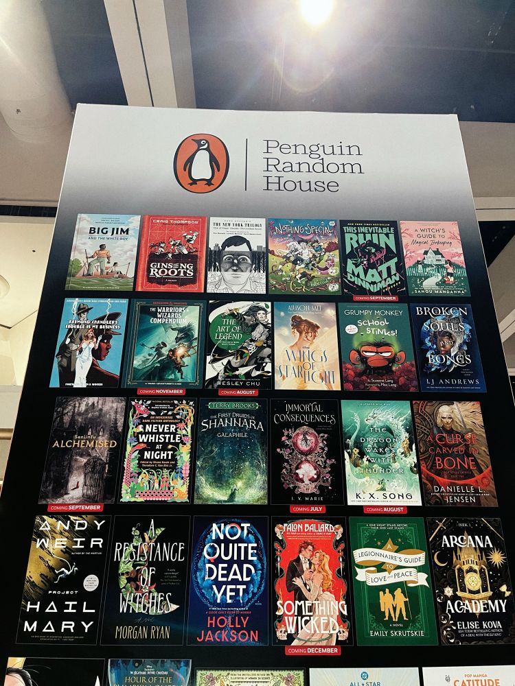 A 20ft tall banner of Penguin Random House book covers at San Diego Comic Con 2025, including Never Whistle at Night: An Indigenous Dark Fiction Anthology