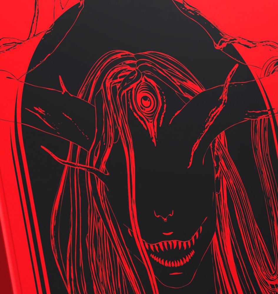 Visage d'un monstre à corne en noir et rouge.