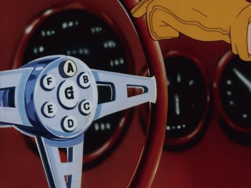Gloved hand pushes legter A on sterring  wheel followed by cut to metalic feet pushiing Speed Racer's car into a jump 