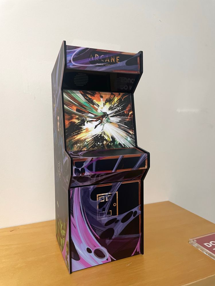 Front of the arcade cabinet, featuring a hex webbing design and the ending space scene