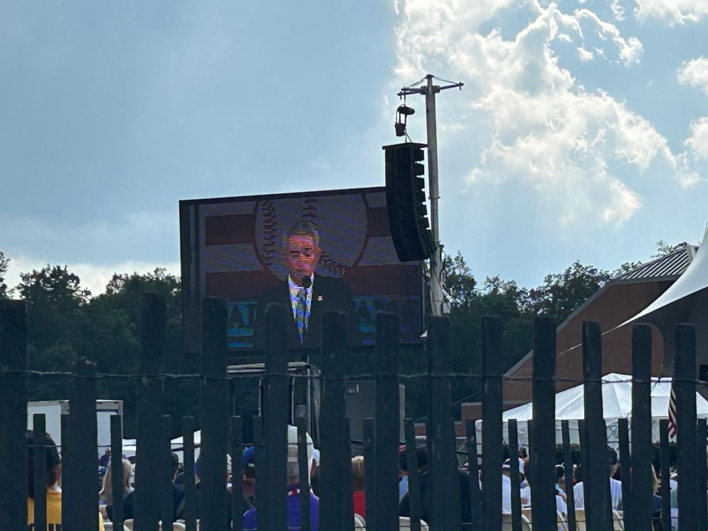 A video screen with newly inducted baseball Hall of Famer Ichiro Suzuki giving his induction speech