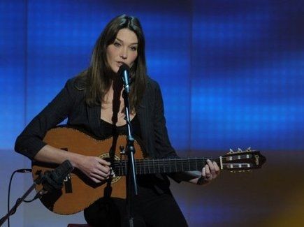 Carla Bruni chante avec une guitare 