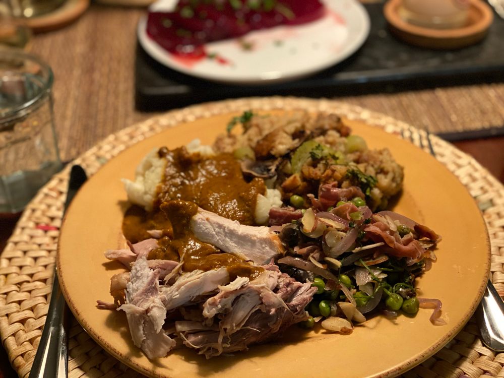 Dhir-Hemphill Thanksgiving plate (2024). Orange and butter-rubbed turkey; turkey drip/roast vegetable gravy, peas with prosciutto, mushrooms, onions, and toasted almonds; stuffing with celery, box mashed potatoes 