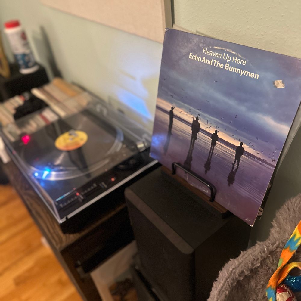 A record player with the sleeve for the Echo and the Bunnymen album Heaven Up Here on a stand in the foreground