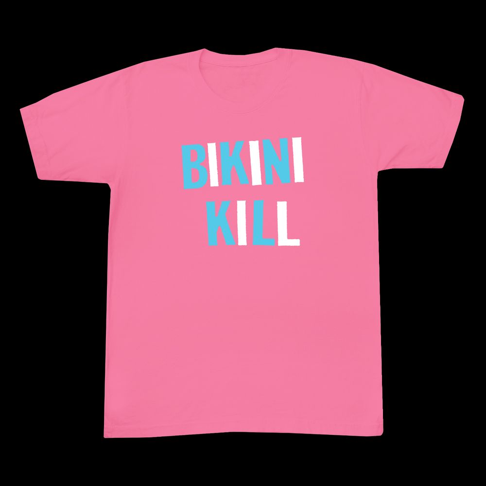 Azalea pink shirt with Bikini Kill written in turquoise and white alternating letters. 
