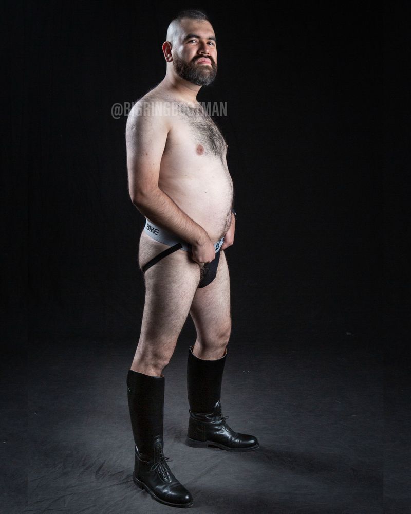 Front side of me wearing a jockstrap with tall boots