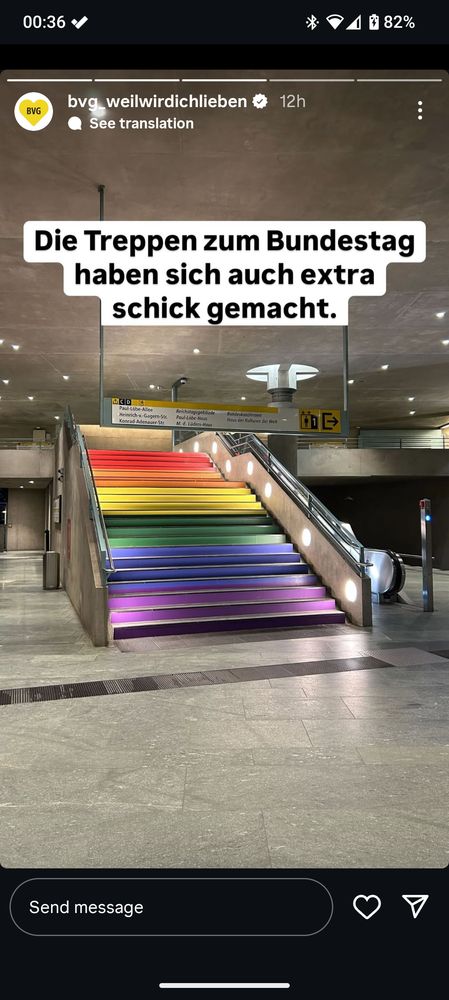 Screenshot of an Instagram reel showing the stairs in the Bundestag Station in Rainbow colors 