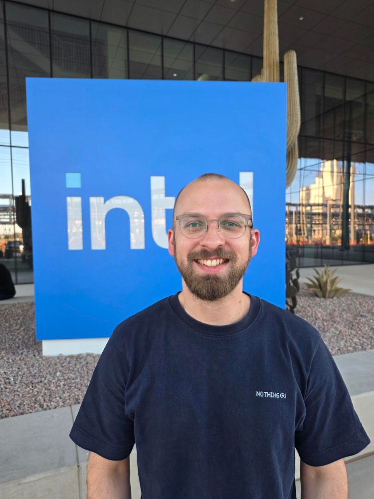 Photo of me in front of an Intel building and logo 