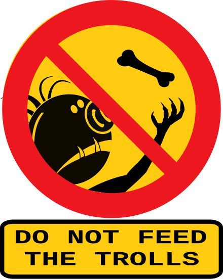 sign reading 'do not feed the trolls' depicting a troll-like creature