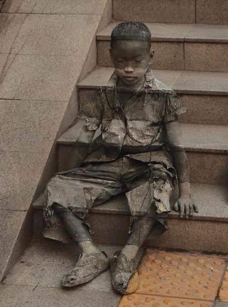 Street art in China, in 2008, created by Kevin Lee, depicting a child sitting on steps - living in poverty, being overlooked by society.