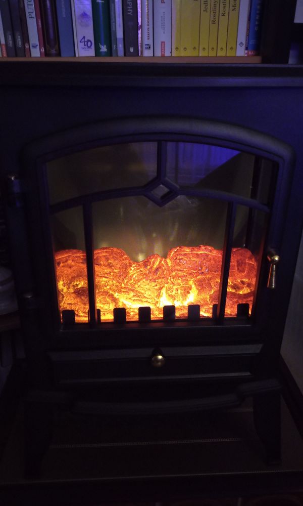 A small electric fireplace, space heater, in an old timey looking design of black cast iron stove with gold details. The fake burning wood looks decent and can be regulated a little.