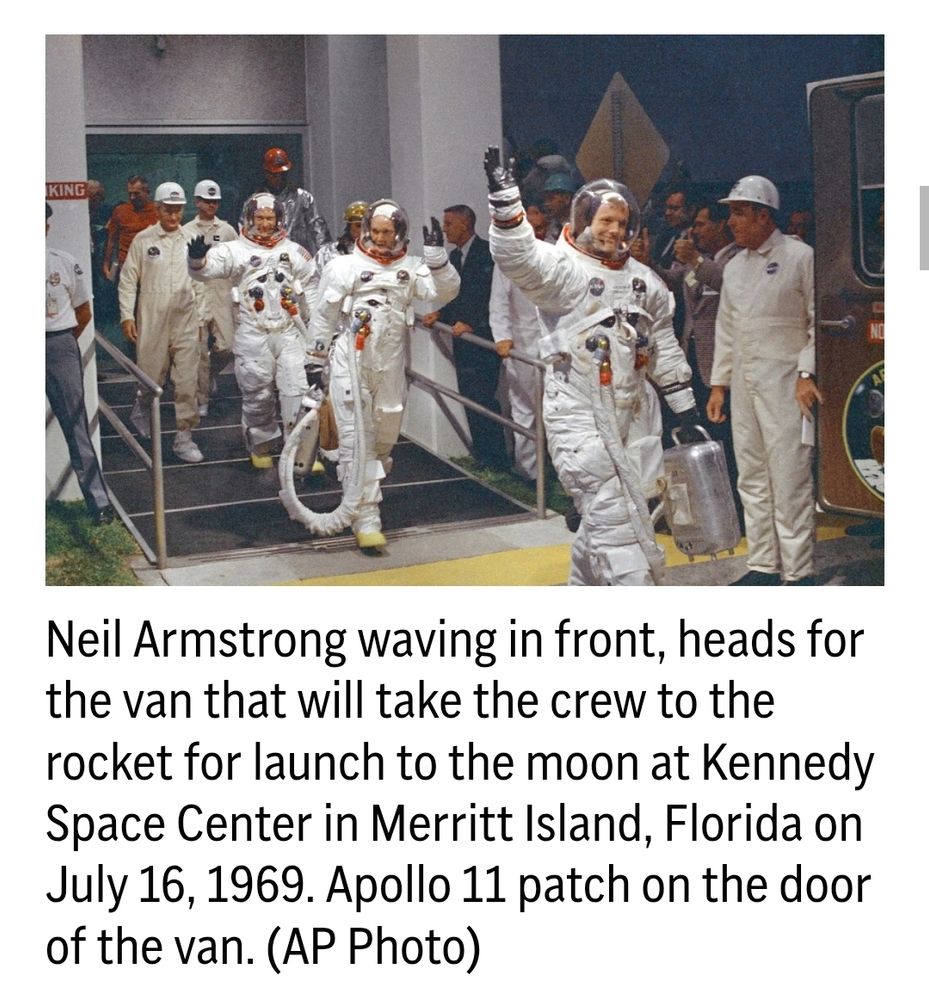 Neil Armstrong waving in front, heads for the van that will take the crew to the rocket for launch to the moon at Kennedy Space Center in Merritt Island, Florida on July 16, 1969. Apollo 11 patch on the door of the van. (AP Photo)