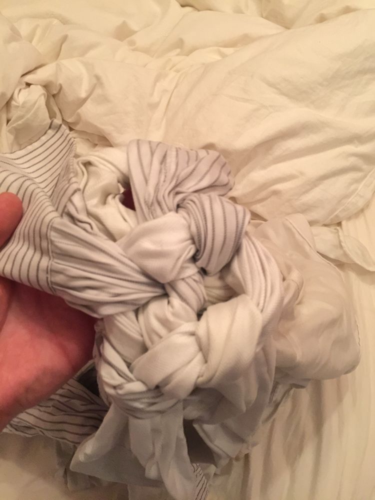 3 shirts with the sleeves knotted together after being in a washing machine 