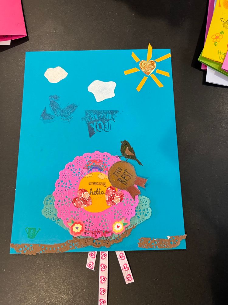 A handmade thank you card featuring less paper doilies, a bird and a sun.