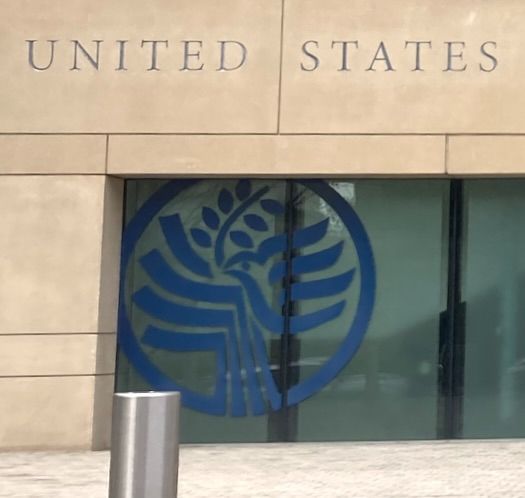 The dove and olive branch logo of USIP painted on the staff entrance to USIP.