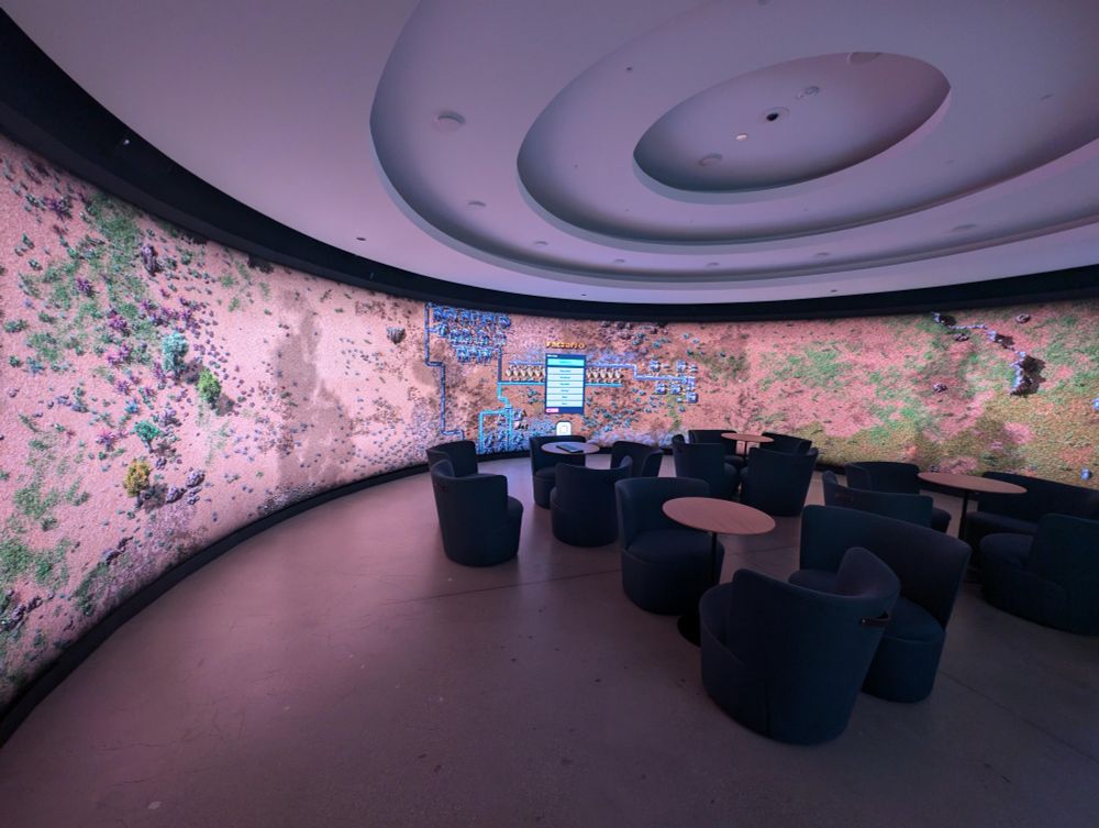 Factorio on a circle wall screen meeting room