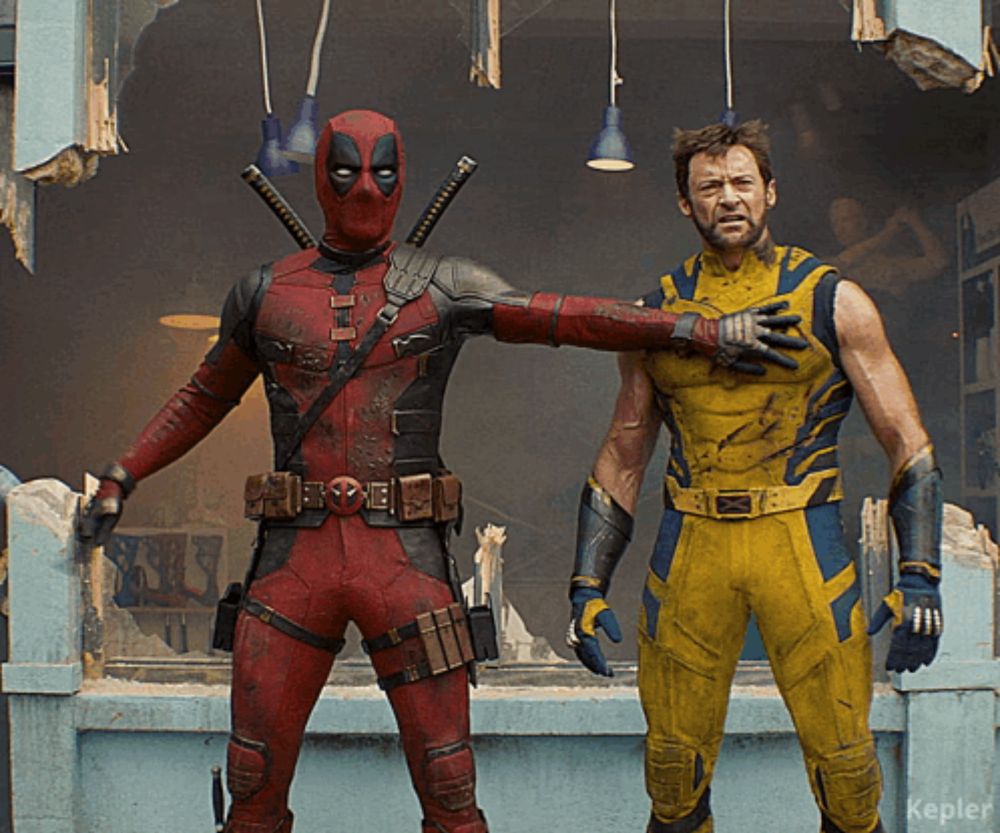 deadpool and wolverine pose for a picture together