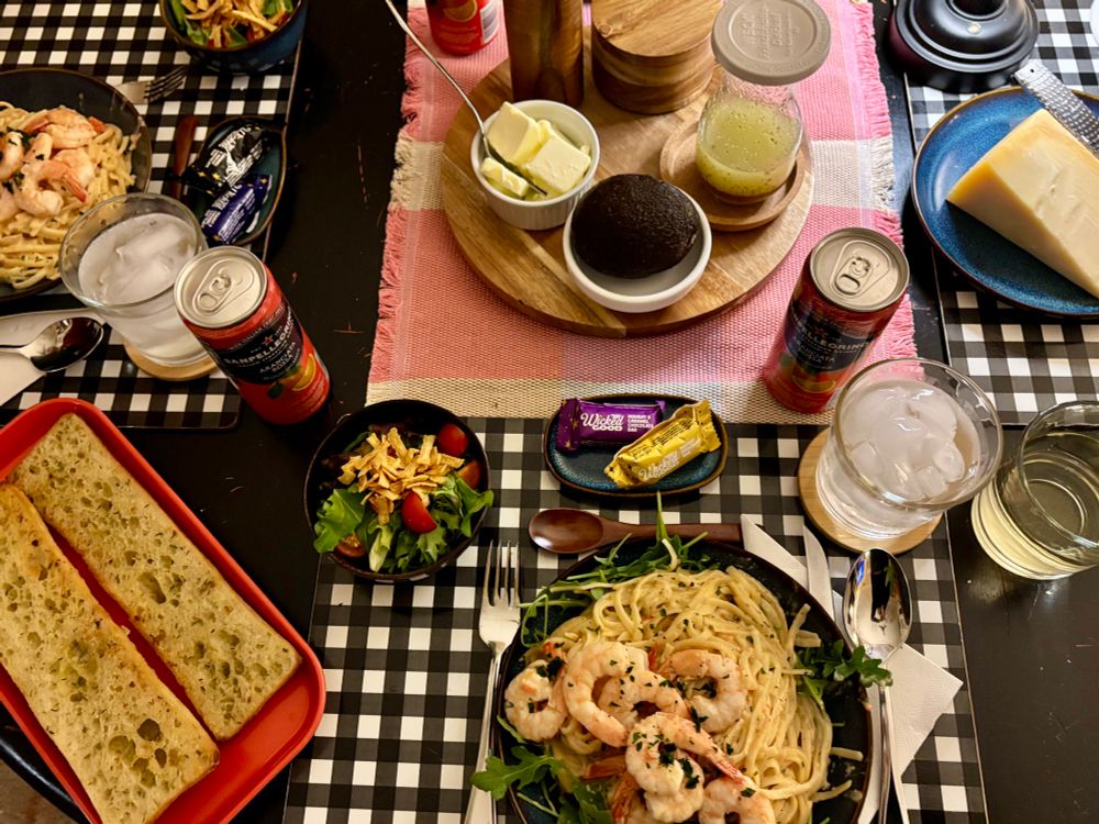 Shrimp linguine with a creamy garlic lemon sauce; garlic ciabatta; salad with tomatoes and cronchies; an avocado and vinaigrette intended for the salad; extra butter that no one used; a hunk of Parmesan; San Pelligrino (Blood Orange) for all and a Sauvignon blanc for moi.