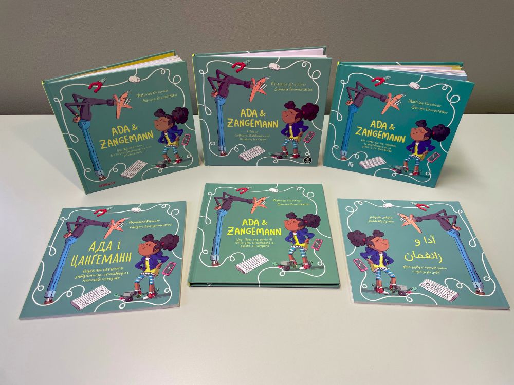 "Picture of Ada and Zangeman books in Arabic, Ukranian, English, French, German, and Italian"