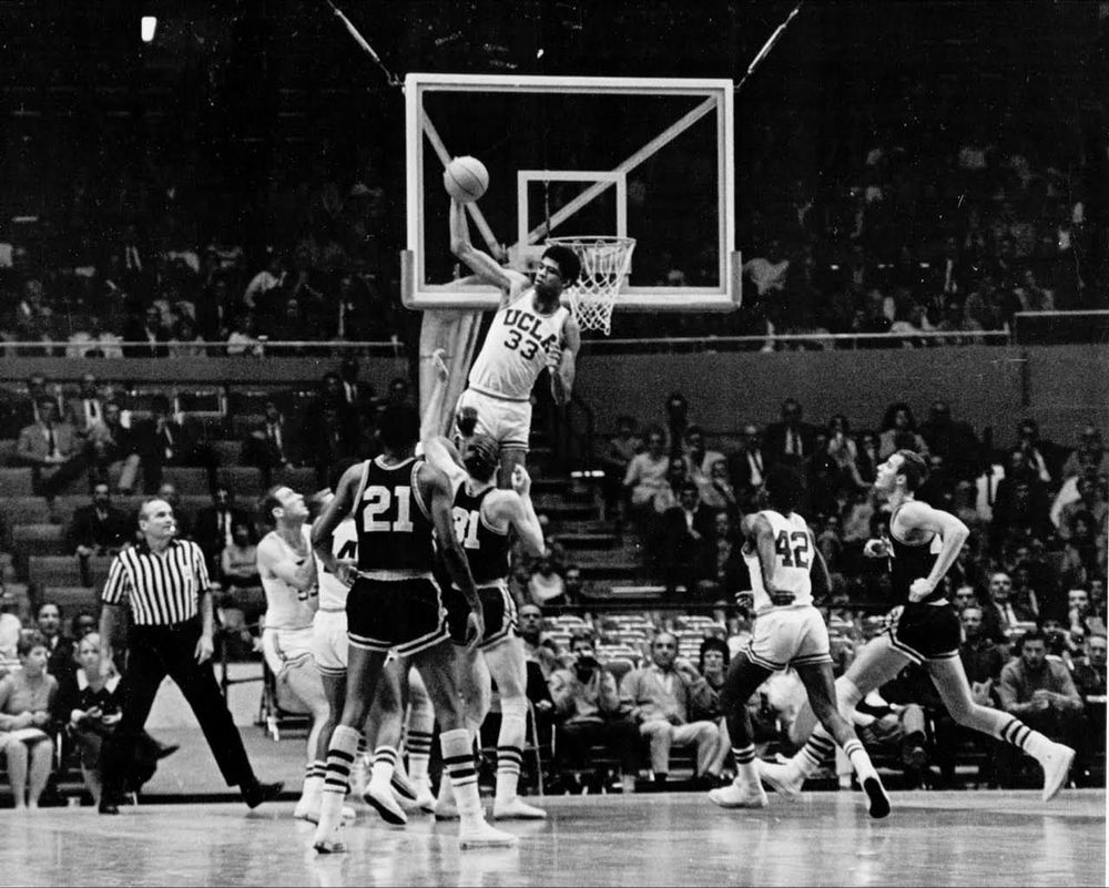 UCLA’s Kareem Abdul-Jabbar blocks a shot by Minnesota’s Larry Mikan 