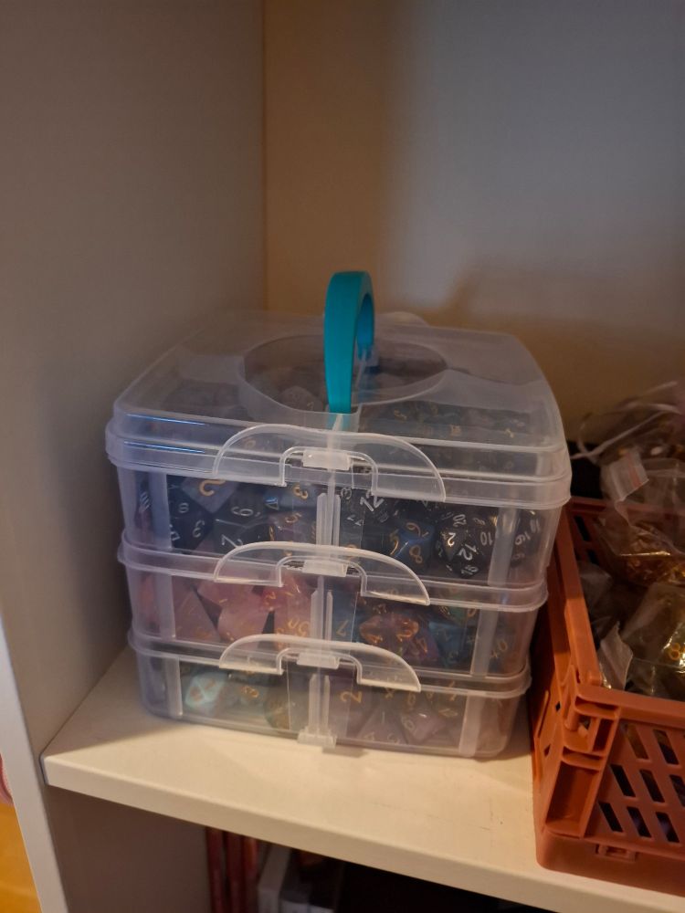 A stackable crafting box filled with dice