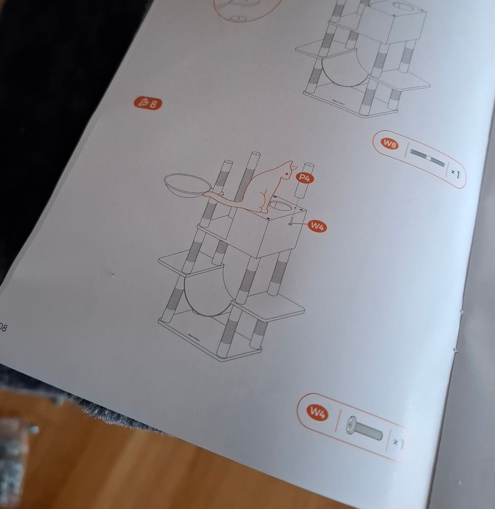 Instructuon booklet for a cat tree with a cat illustration on it