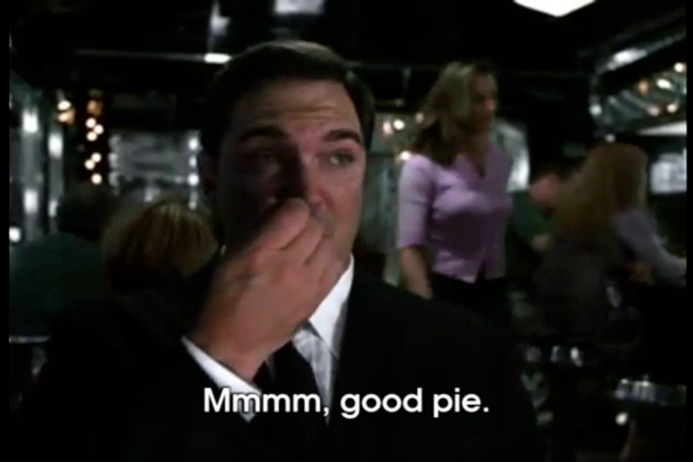 a man in a suit and tie says good pie