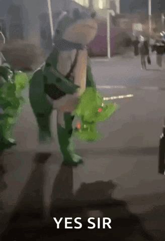 a frog in a green costume is walking down a street with the words `` yes sir '' written on the bottom .