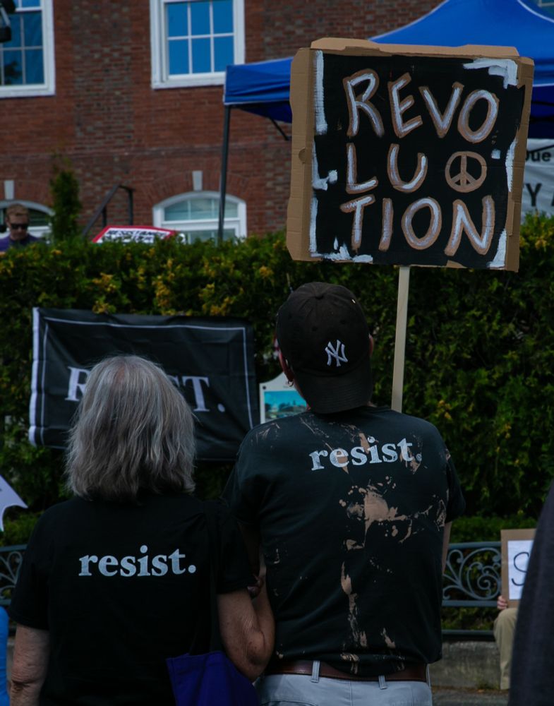 Two people wearing black t-shirts the read 