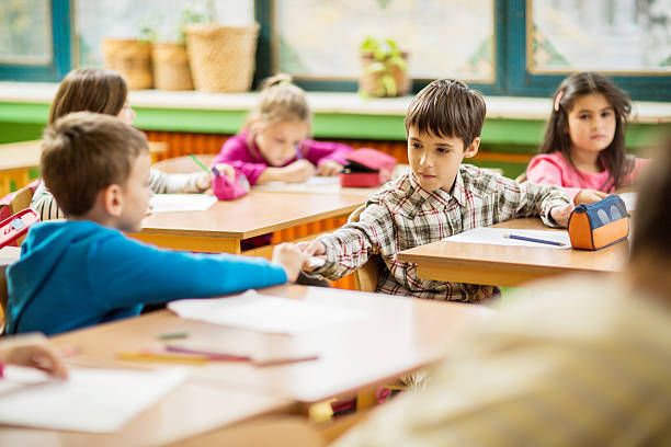 Children passing notes in the classroom