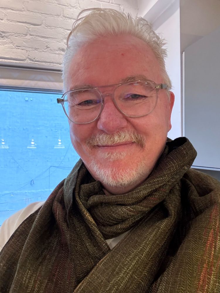 man in an aurora-green scarf 