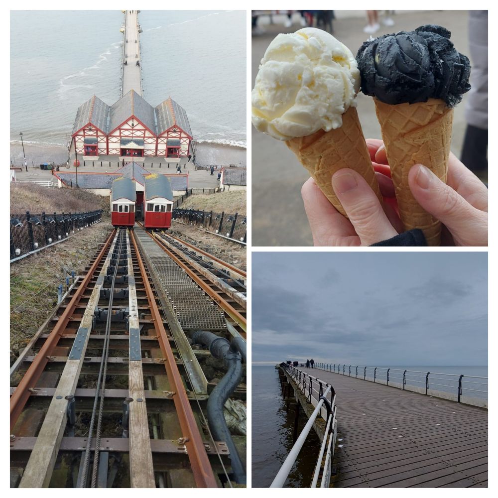 Looking down on the sea-lift, a white chocolate ice cream cone and a black vanilla ice cream cone. View of the sky with pier in foreground. 