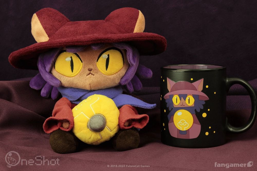 A photo of our official Niko plush next to the Niko color-changing mug. Niko is holding the included plush lightbulb accessory. 