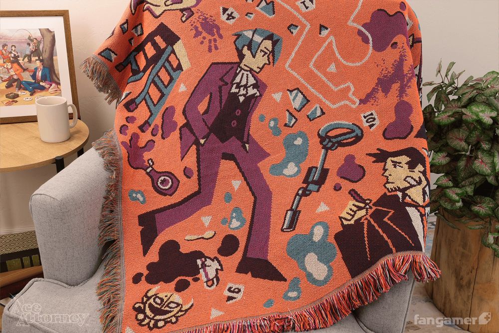 A photo of our new Ace Attorney throw blanket, showing illustrations of Edgeworth and Gumshoe as well as a pattern of items from the game and crime-scene debris against an orange background. 