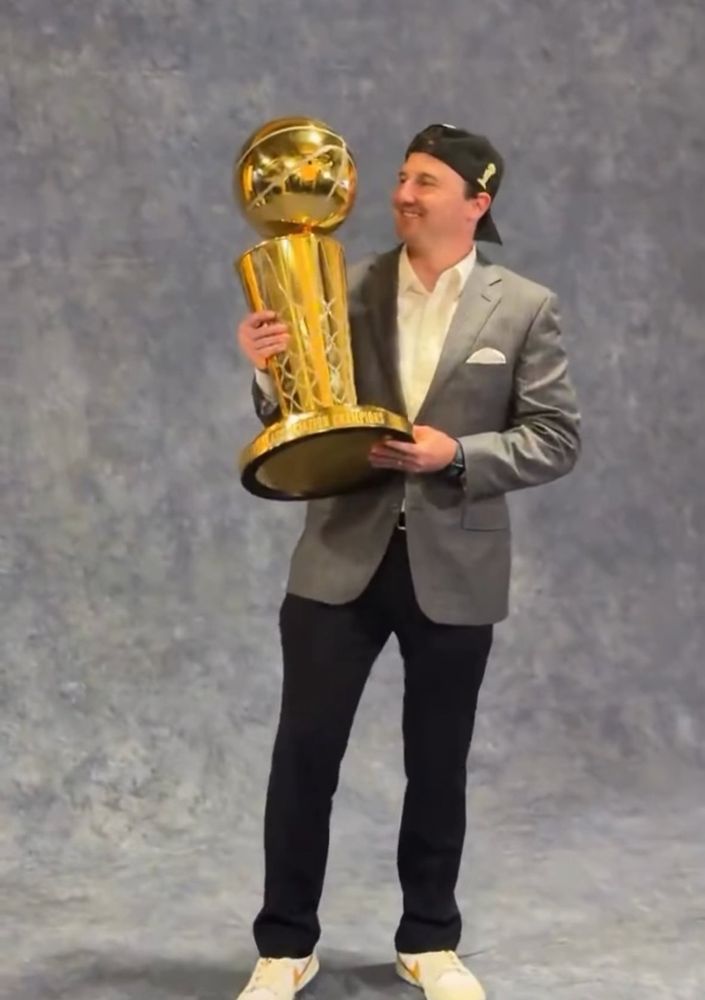Beloved Thunder sideline reporter Nick Gallo holds the Larry O’Brien trophy 
