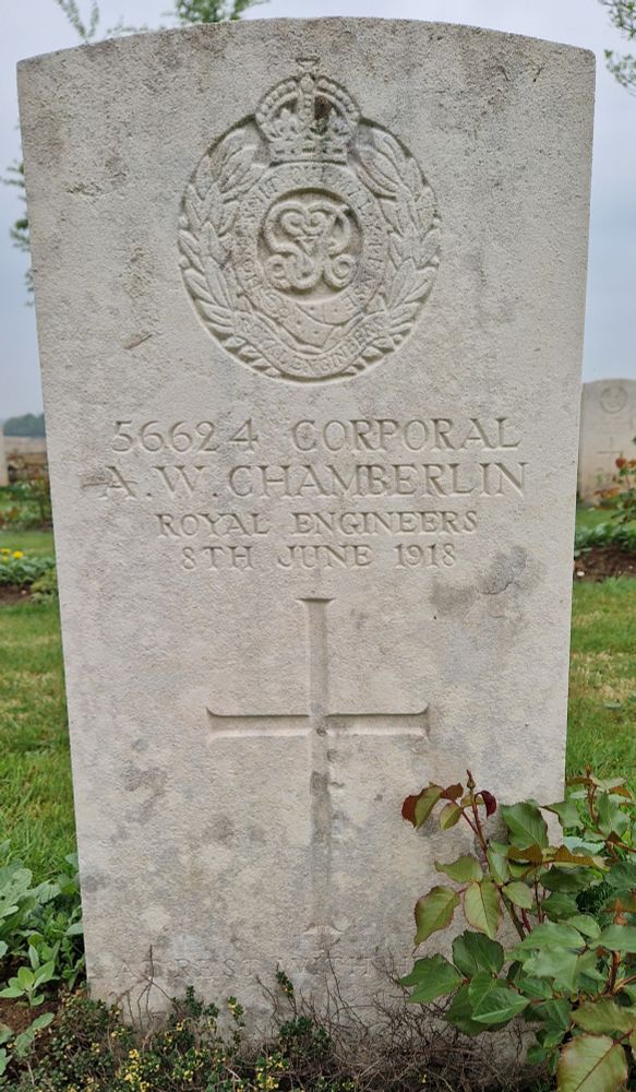 British Military Gravestone in the name of Corporal A W Chamberlin of the Royal Engineers. His regimental crest is above his name, a simple cross below the date of his death, 8th June 1918
