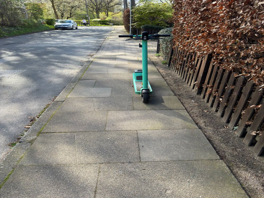 Scooter parked on the pavement causing an obstruction