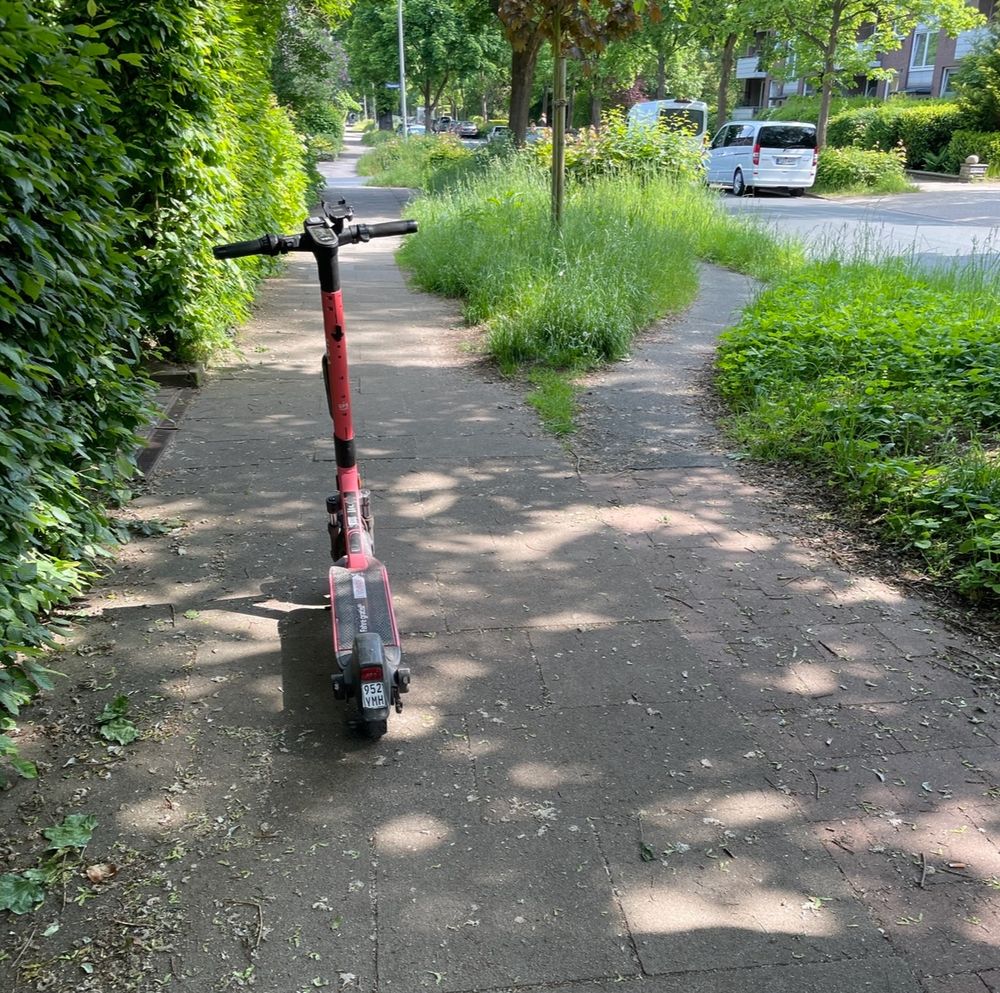 Scooter parked on the pavement causing an obstruction