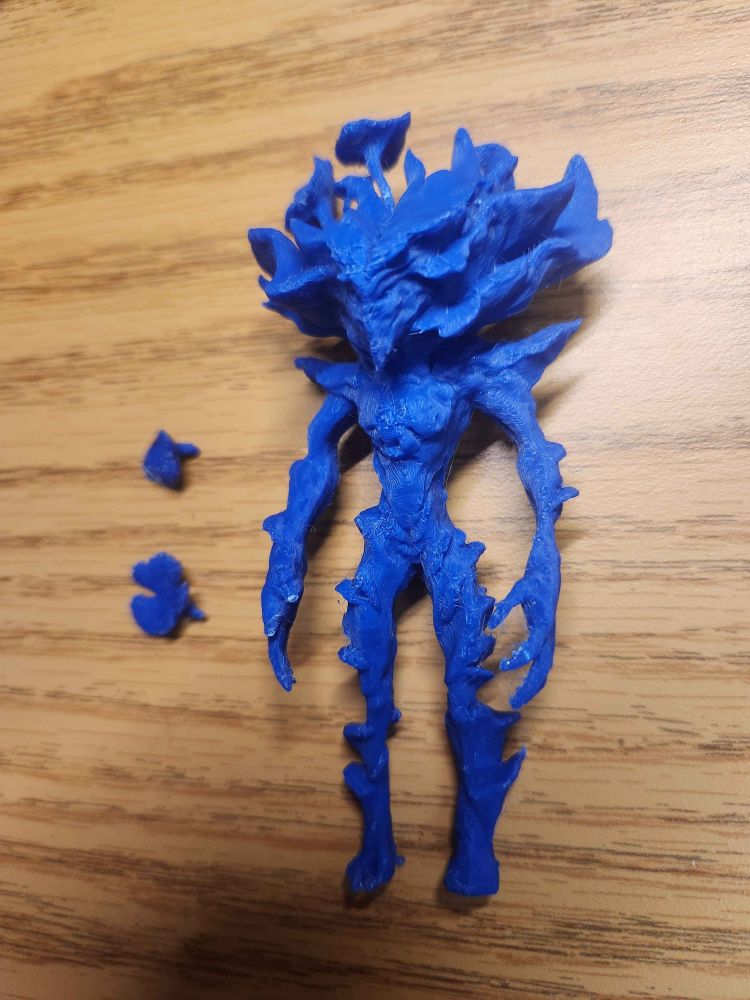 The same figurine at an angle showing its left side and two broken off mushrooms