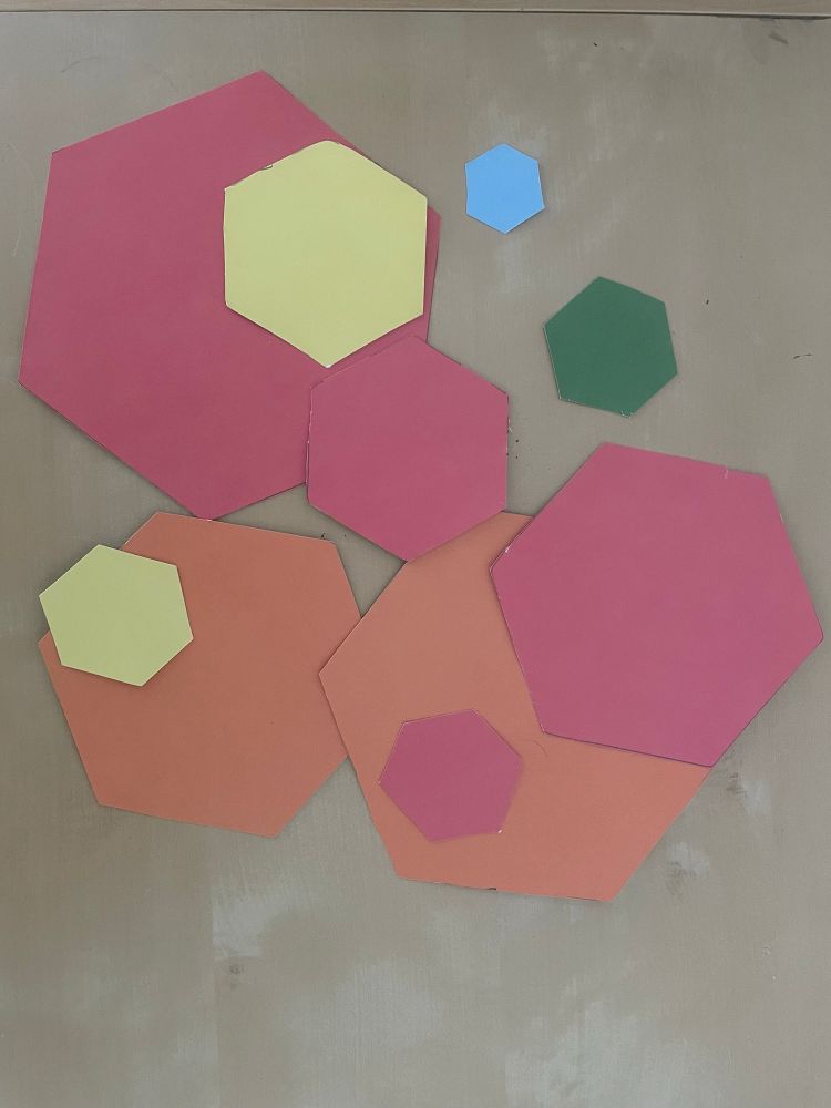 A selection a variously sized hexagons of various vibrant colors. 