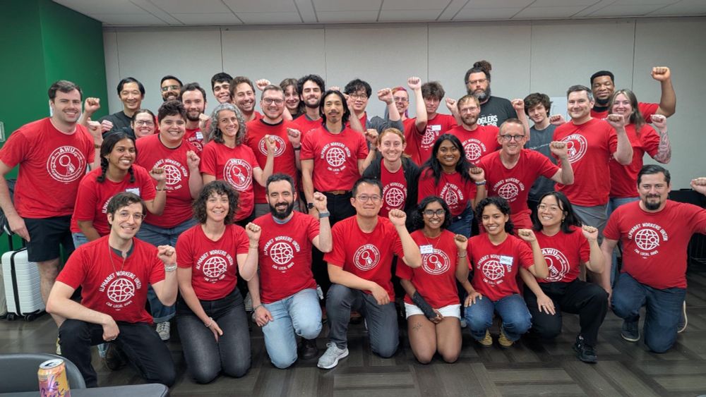 a photo of a big group of Alphabet Workers Union members on the East Coast wearing their red union tshirts and raising their fists.