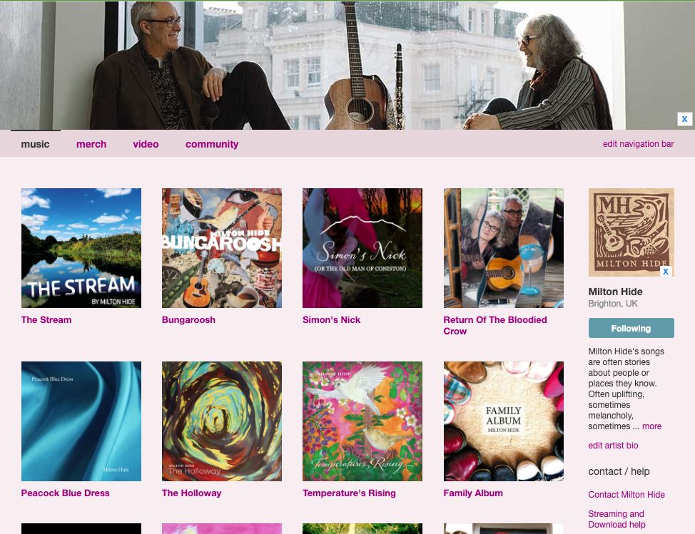 screen shot of bandcamp page, couple sit facing eachother with guitar between, images of albums and singles include The Stream, Bungaroosh, Simon's Nick, Return Of The Bloodied Crow, Peacock Blue Dress, The Holloway, Temperature's Rising, Family Album. The Milton Hide logo is brown lino cut style showing nightingale, guitar and clarinet
