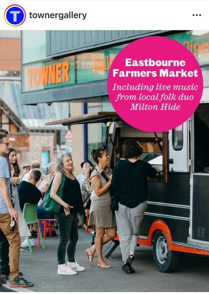Queue of happy looking people at food van in front of the Towner art gallery with pink circle flash reading Eastbourne Farmers Market, including live music from local folk duo Milton Hide 