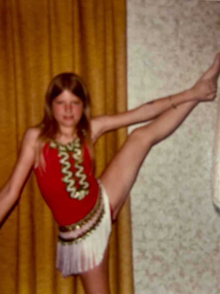Young girl preparing for her acrobatics recital 