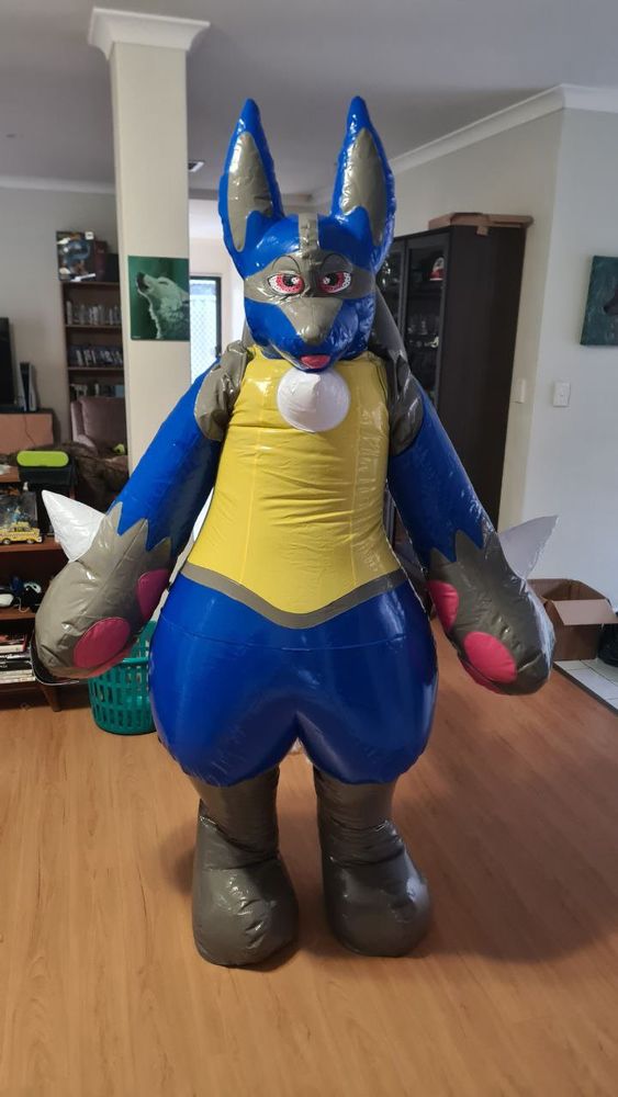 A cutie wearing a big inflatable Lucario suit standing there, not able to do anything
