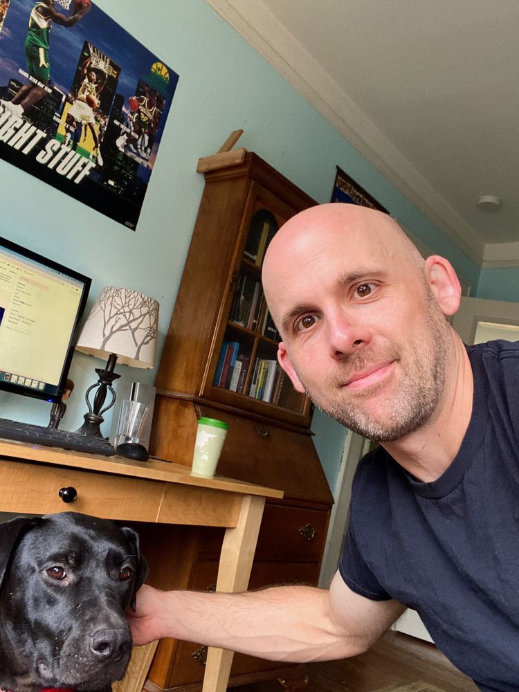 A selfie of me and Toby at my desk (vintage 1994 Seattle Supersonics 