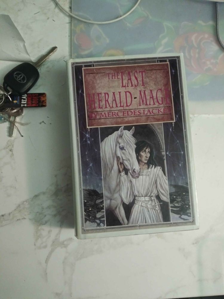 The Cover to The Last Herald-Mage Omibus. This was one Published in 1990 and was the prettiest of the options though had to be bought through Ebay. The Library card on my keeps say "I read Banned Books".