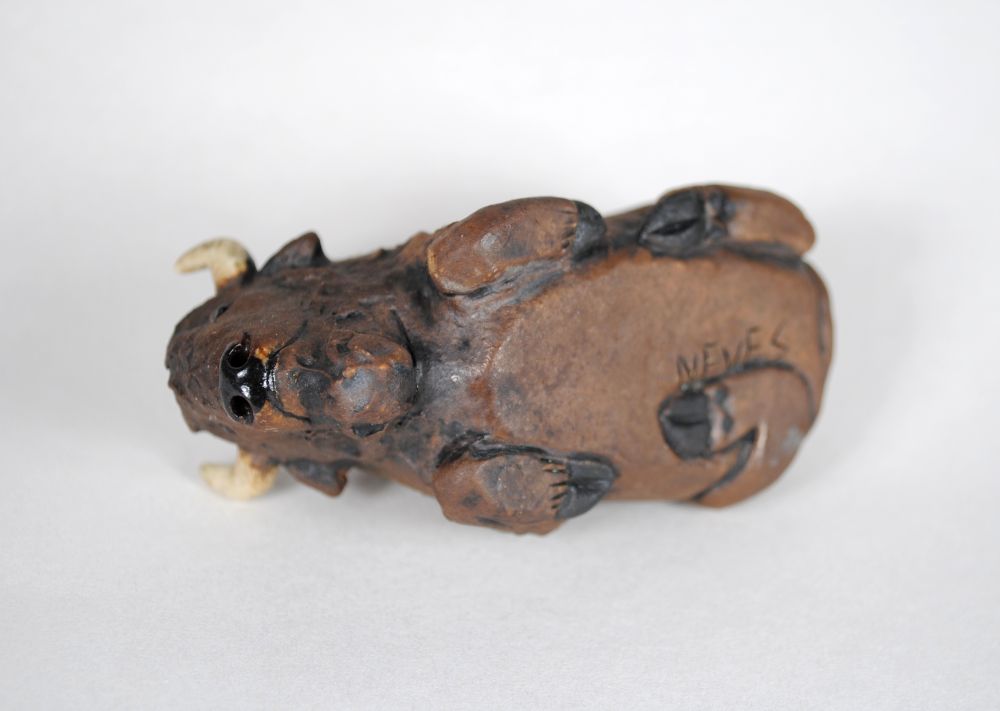 underside view of the bison pipe, where you can see the hoof details and the leg that is tucked under him.