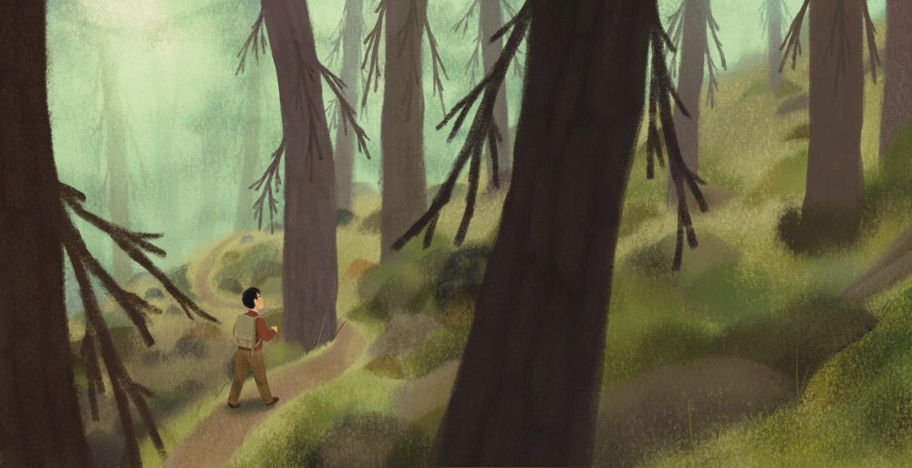 A young man hiking in the woods.