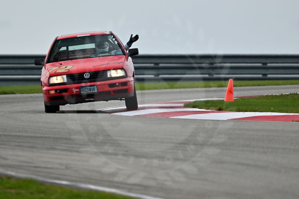 Jeremy Bryner photo for Downforce Media; hand out of the window while on the turn 3 apex curb at Pittsburgh International Race Complex during the final SCCA Track Night